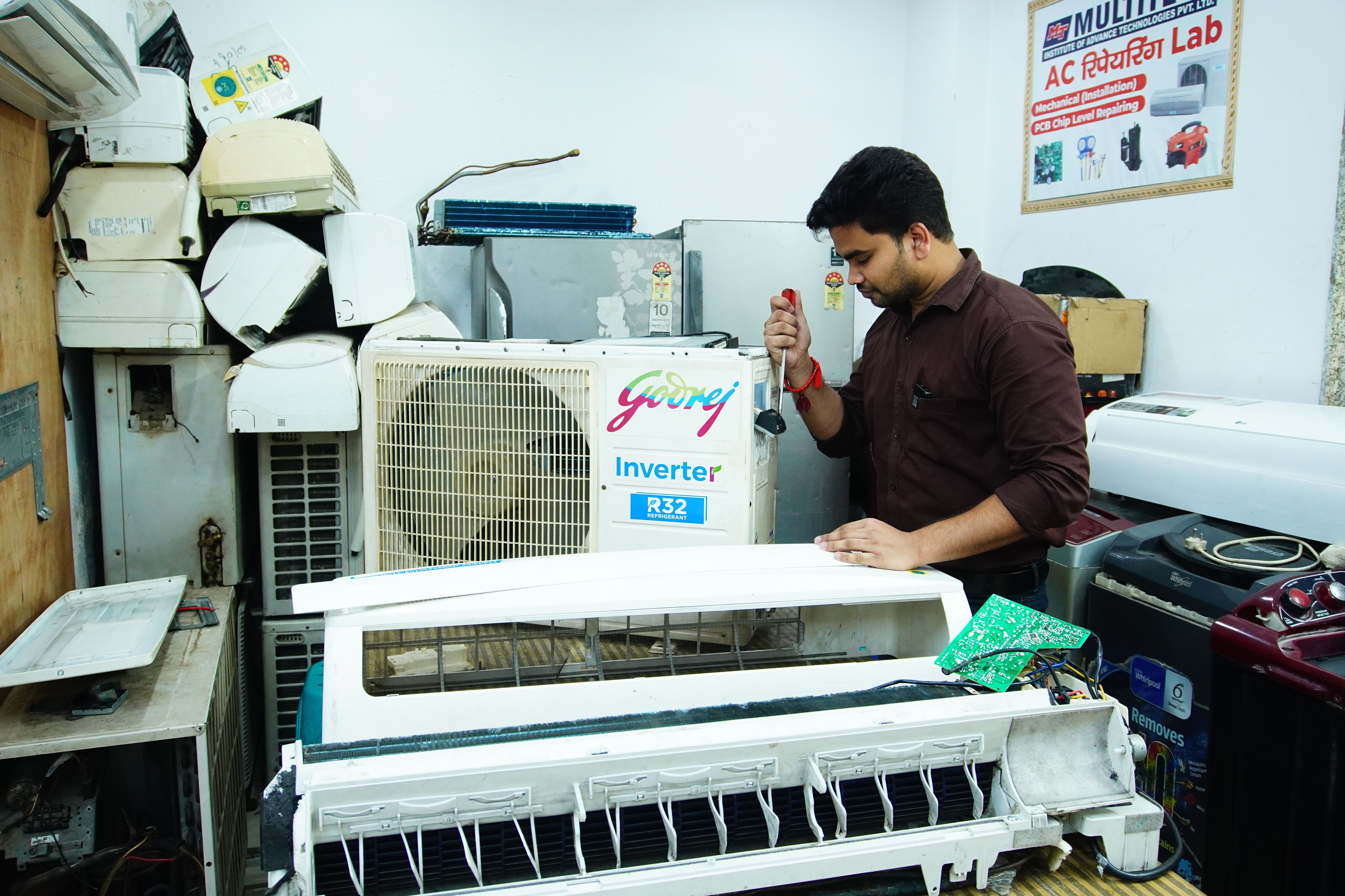 Professional technician repairing a split air conditioner